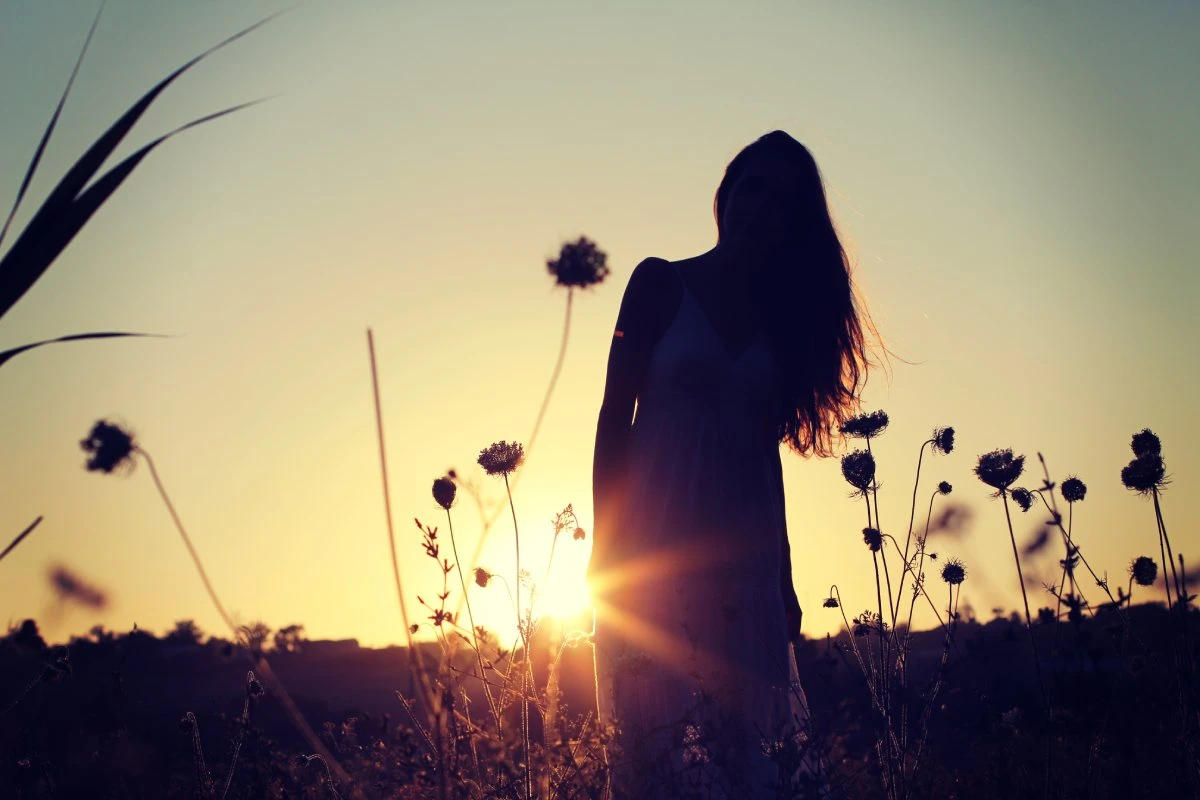 Beautiful silhouette of a girl in a field