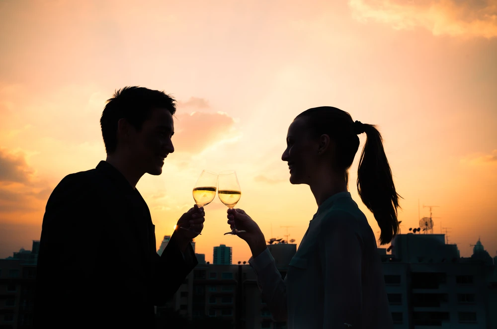 Silhouette of a couple having wine