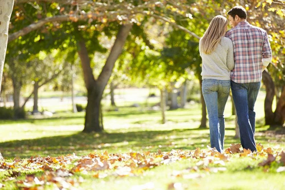 Romantic couple walking through the park