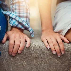 Close up of a pair of hands of a young couple on a first date